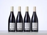 three bottles of wine are lined up on a table