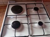 a white stove top with four burners on it