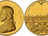 a close up of a gold coin with a picture of a man on it