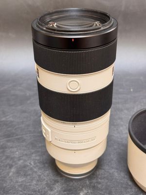 a camera lens sitting next to a coffee cup on a table