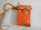 a small leather case with a metal clasp on it