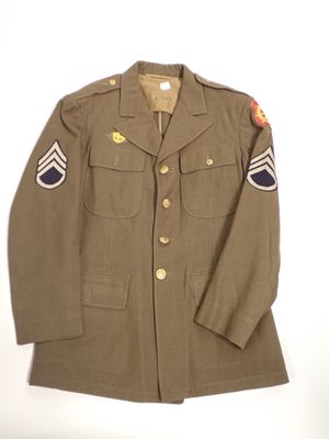 an army uniform jacket with patches on the sleeves and shoulder