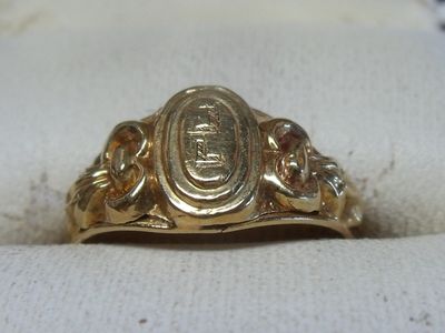 a close up of a gold ring on a white cloth