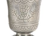 a silver cup that is sitting on a pedestal