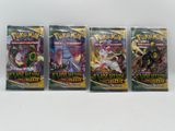 three packs of pokemon trading cards are sitting on a table