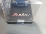 a blue toy car in a clear box on a table