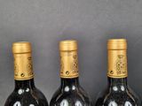 three bottles of wine that are sitting on a table
