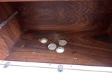 a wooden box with buttons and screws inside of it