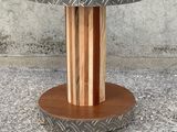 a close up of a wooden table with a metal plate on it