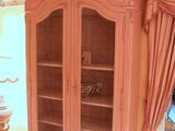 a pink cabinet in the corner of a room
