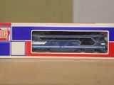 a blue and red train in a box on a table