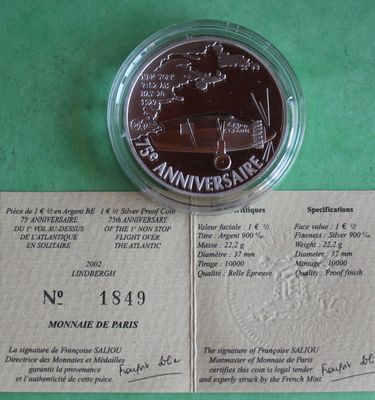a close up of a piece of paper with a coin on it