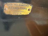 a close up of a black suitcase with a gold label