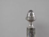a silver bottle with a silver lid on a table