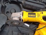 a yellow corded drill and a black tool in a black case