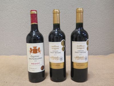 trois bouteilles de vin posées sur une table, l'une à côté de l'autre