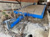 une boîte bleue posée par terre à côté d'un immeuble