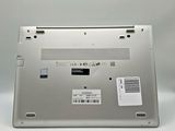 an open laptop computer sitting on top of a white surface