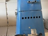 a blue machine sitting on a shelf in a store