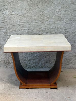 an image of a small table with a marble top on a sidewalk