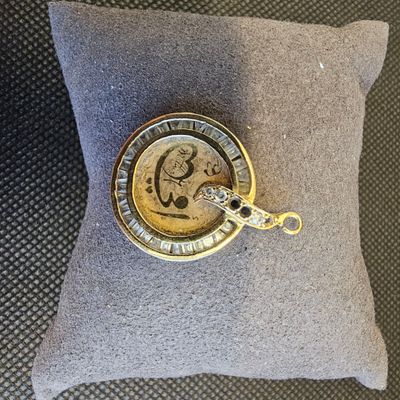 une montre de poche posée sur un oreiller, par terre