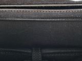 a black purse with a zipper on the inside of it