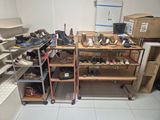 many pairs of shoes on the shelves in the room