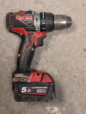 a close up of a cordless drill on the ground