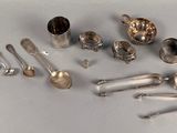 a lot of silver spoons and utensils on the table