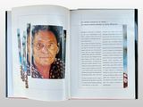 an open book with a picture of a man in glasses on it