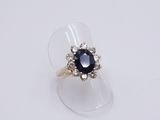 a close up of a ring with a blue stone in it