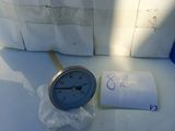a clock that is sitting on a table next to a bag