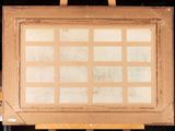 an old picture frame with a grid of squares on it sitting on a easel