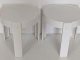 pair of white round side tables with handles on each side