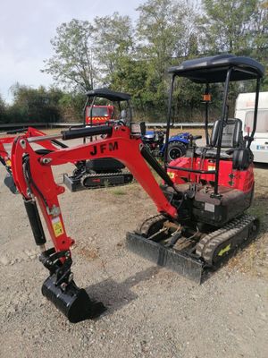 a small excavator that is parked in the dirt