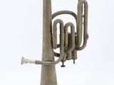 a small brass instrument that is sitting on a stand