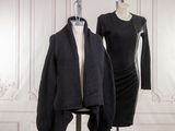 two mannequins and a dress on a mannequin stand in front of a white wall