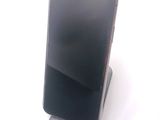a cell phone that is sitting on top of a stand