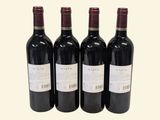 three bottles of red wine are lined up in a row