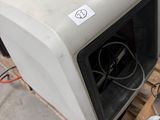 an old microwave sitting on a pallet in a warehouse