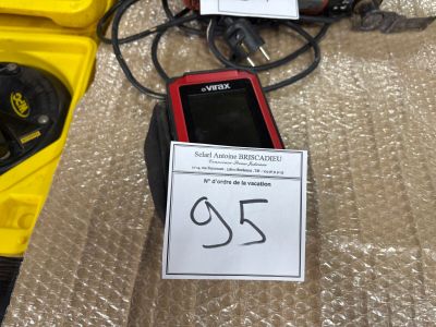 un téléphone portable rouge posé sur une table, à côté d'une boîte jaune