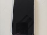 an image of a black cell phone sitting on top of a white table