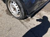 a shadow of a person standing next to a car