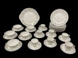 a lot of plates and cups and saucers on the table