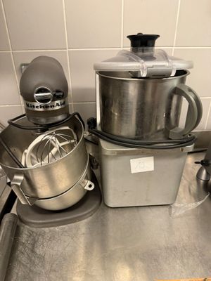 a silver mixer on the counter in the kitchen