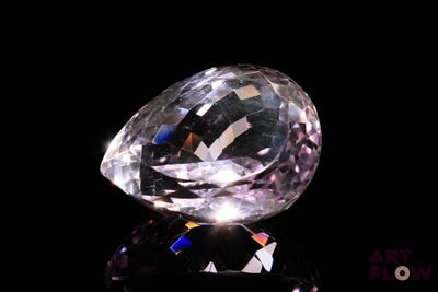 an image of a diamond on a black surface with a black background