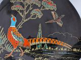 a decorative plate with a pheasant and a bird on it