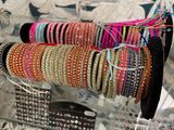 many bracelets on display in a glass case