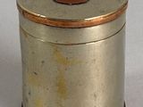 a small silver box with a brown lid