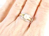 an image of a woman ' s hand with a ring on it